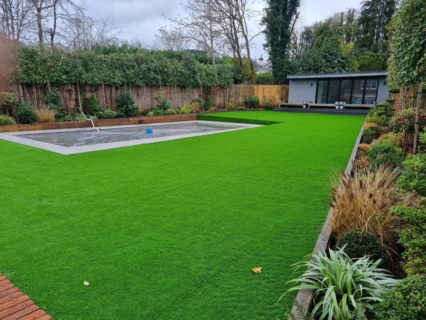 Artificial grass lawn in bright summer conditions